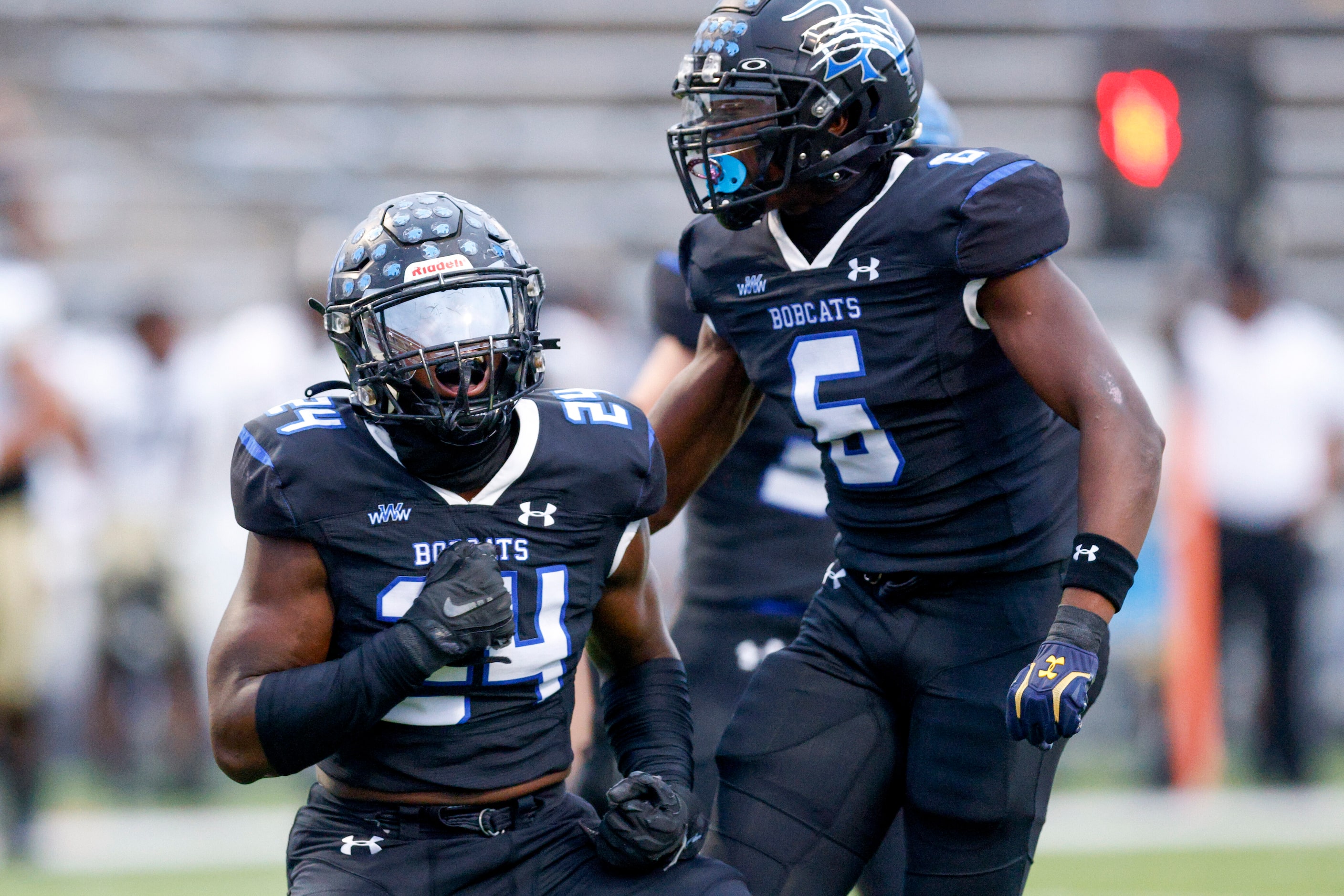 Trophy Club Byron Nelson’s Rubben Tshilombo (24) celebrates a sack with Ashton Williams (5)...