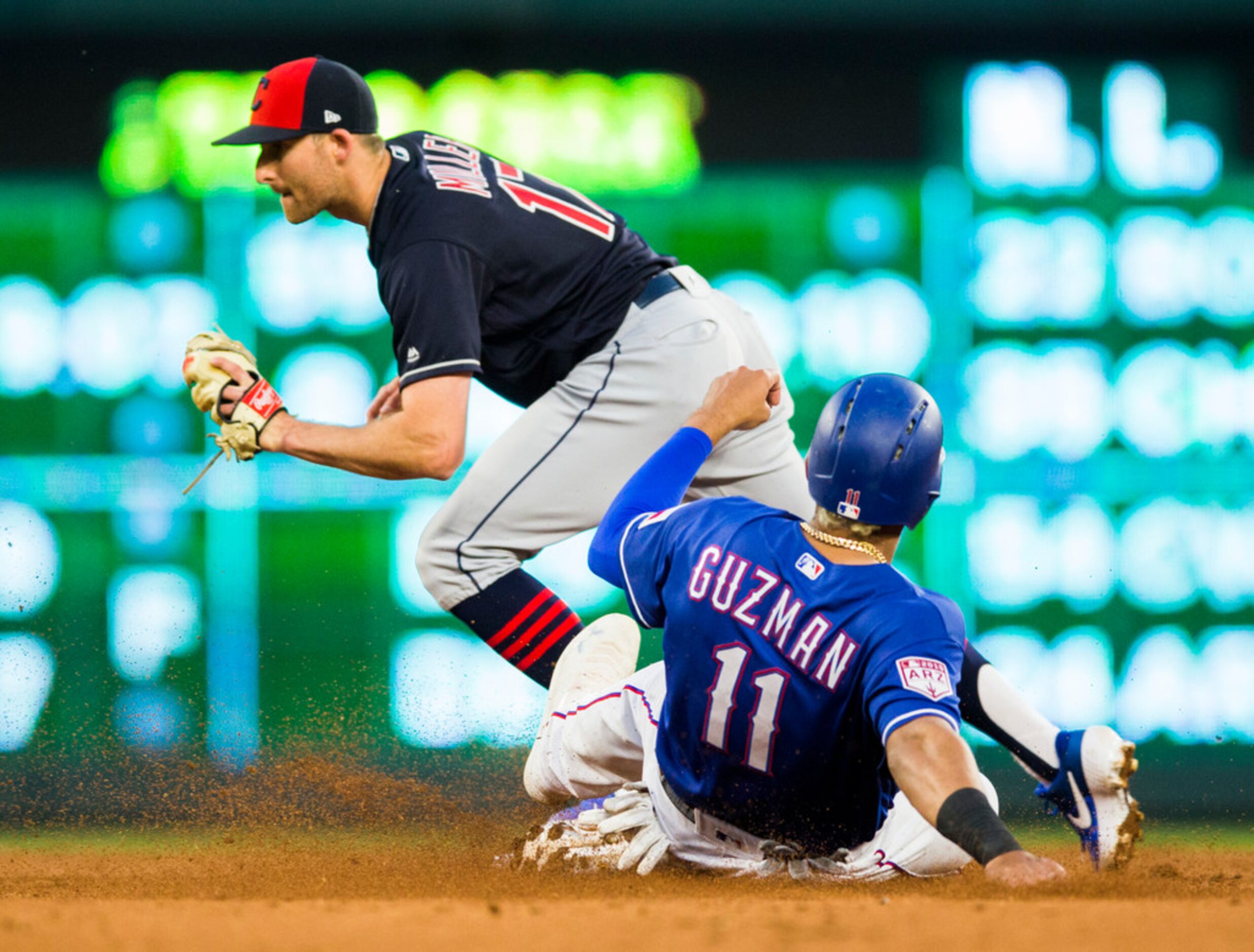 Texas Rangers first baseman Ronald Guzman (11) is out at third base with a catch by...