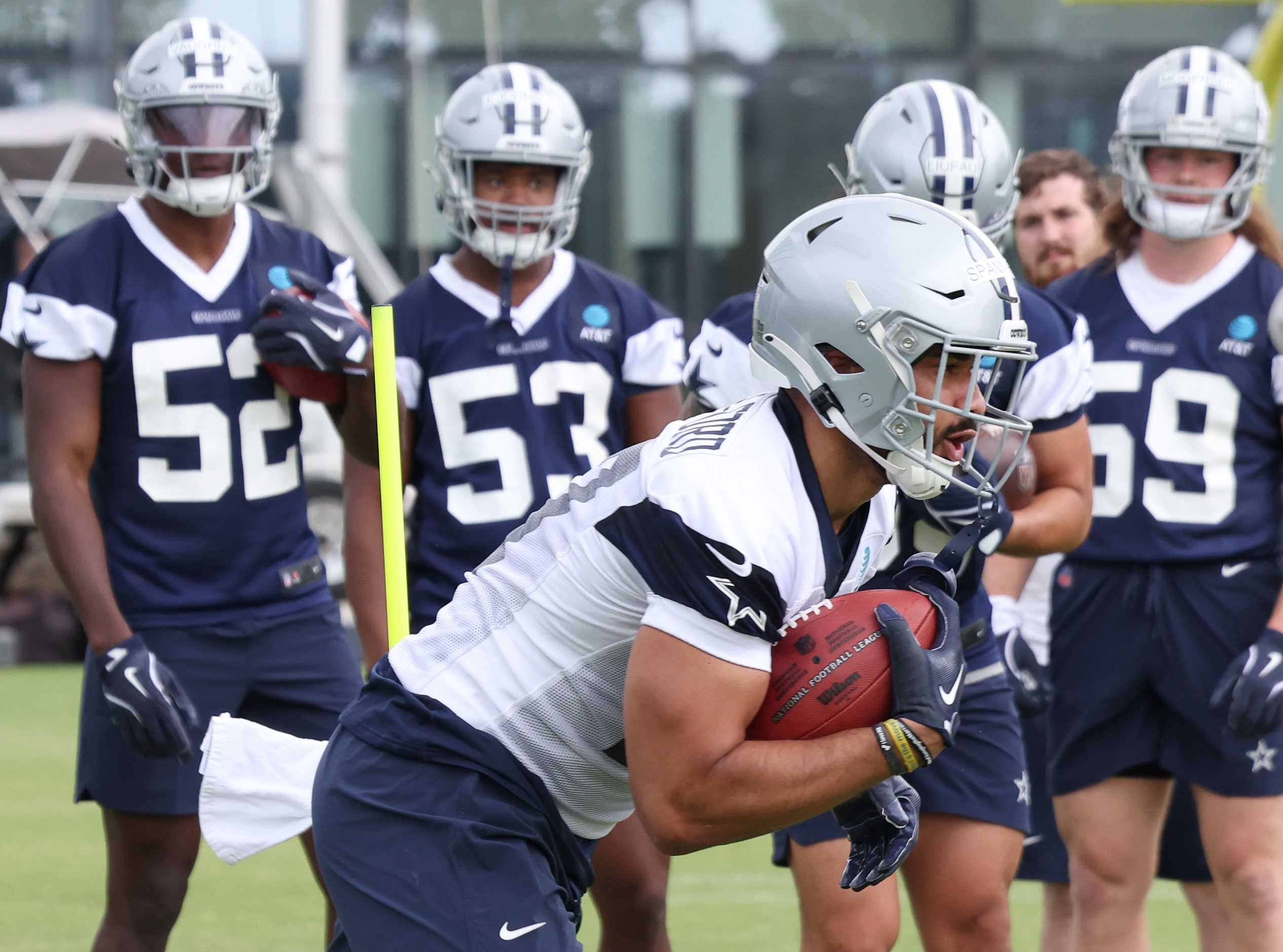 Dallas Cowboys tight end Brevyn Spann-Ford (47) runs through a drill as other players look...