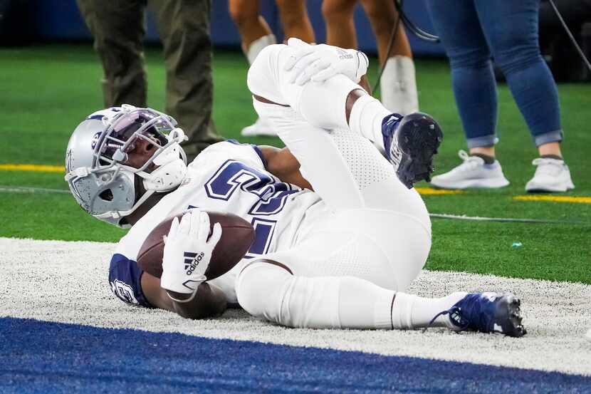 Dallas Cowboys wide receiver Michael Gallup grabs his left knee after he was injured on a...