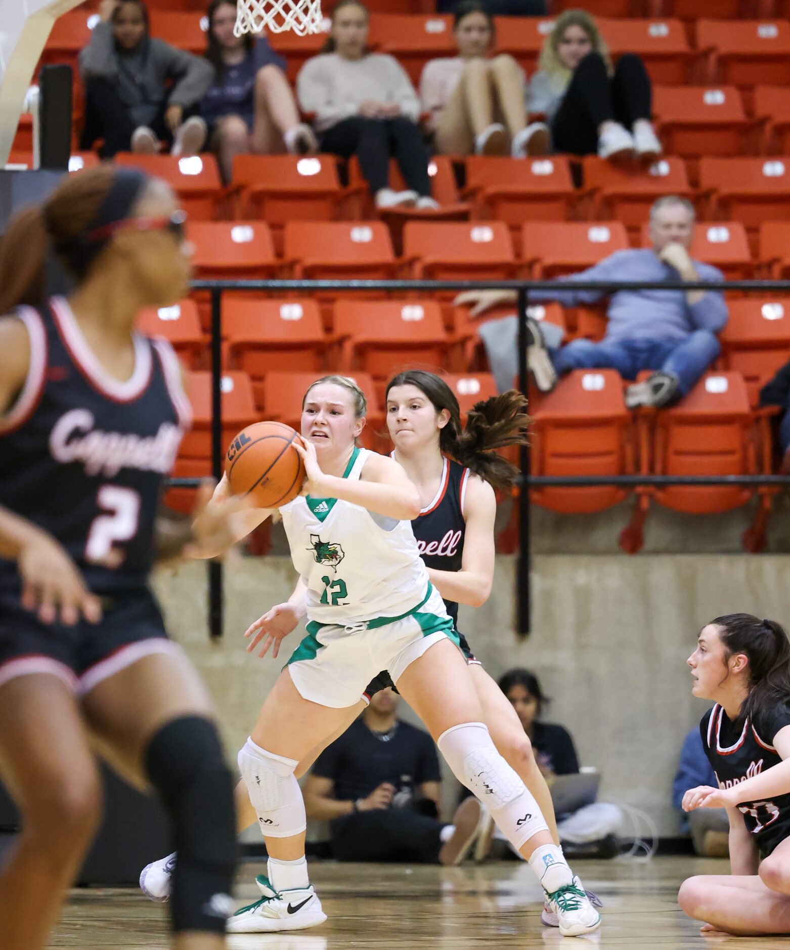 Southlake Carroll junior forward Taryn Barnes (12) passes the ball with pressure from...