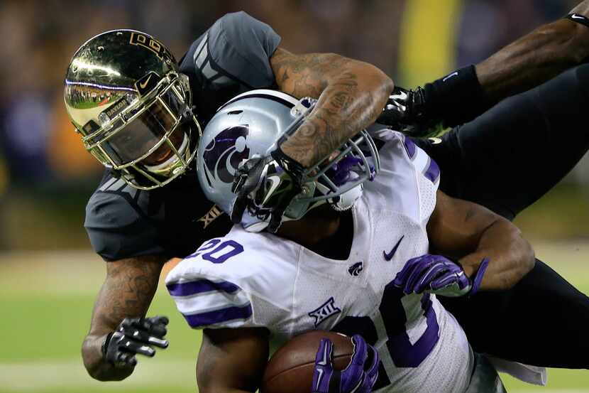 WACO, TX - DECEMBER 06:  DeMarcus Robinson #20 of the Kansas State Wildcatsis tackled by...