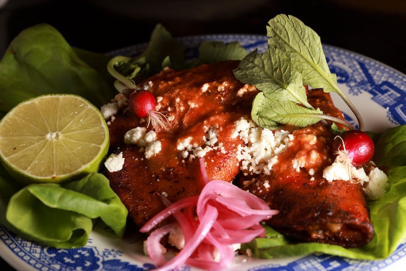 A plate of Enchiladas de Codorniz at Revolver Taco Gastro Cantina 