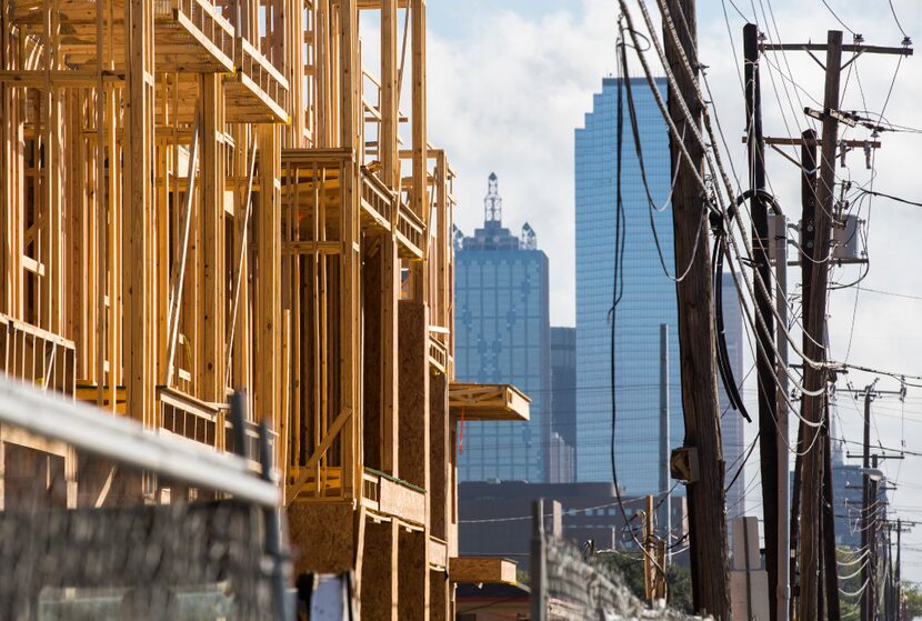 The Broadstone Trinity Grove apartments, left, under construction on Tuesday, October 12,...