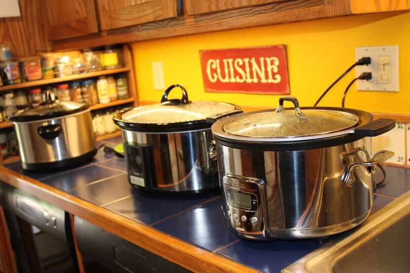 Cheryl Alters Jamison's three slow cookers, lined up and cooking. She borrowed others for...