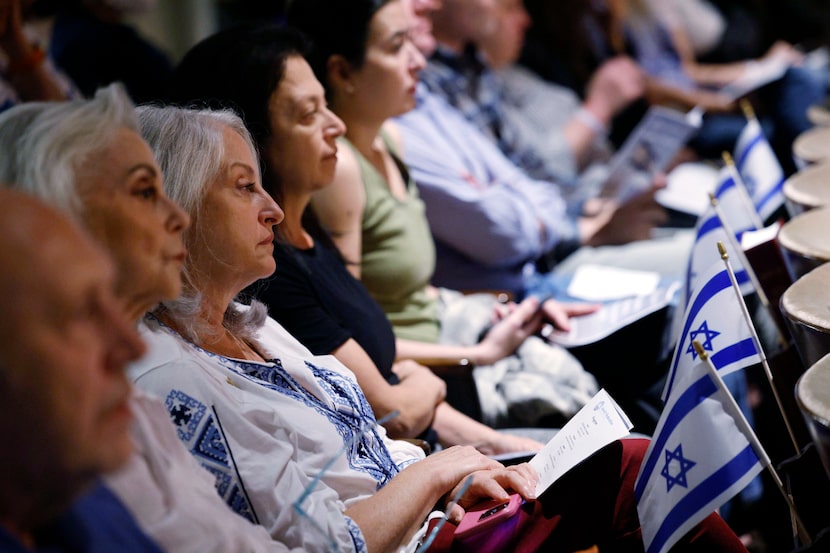 People attend a community solidarity gathering for Israel at Temple Emanu-El, Tuesday, Oct....