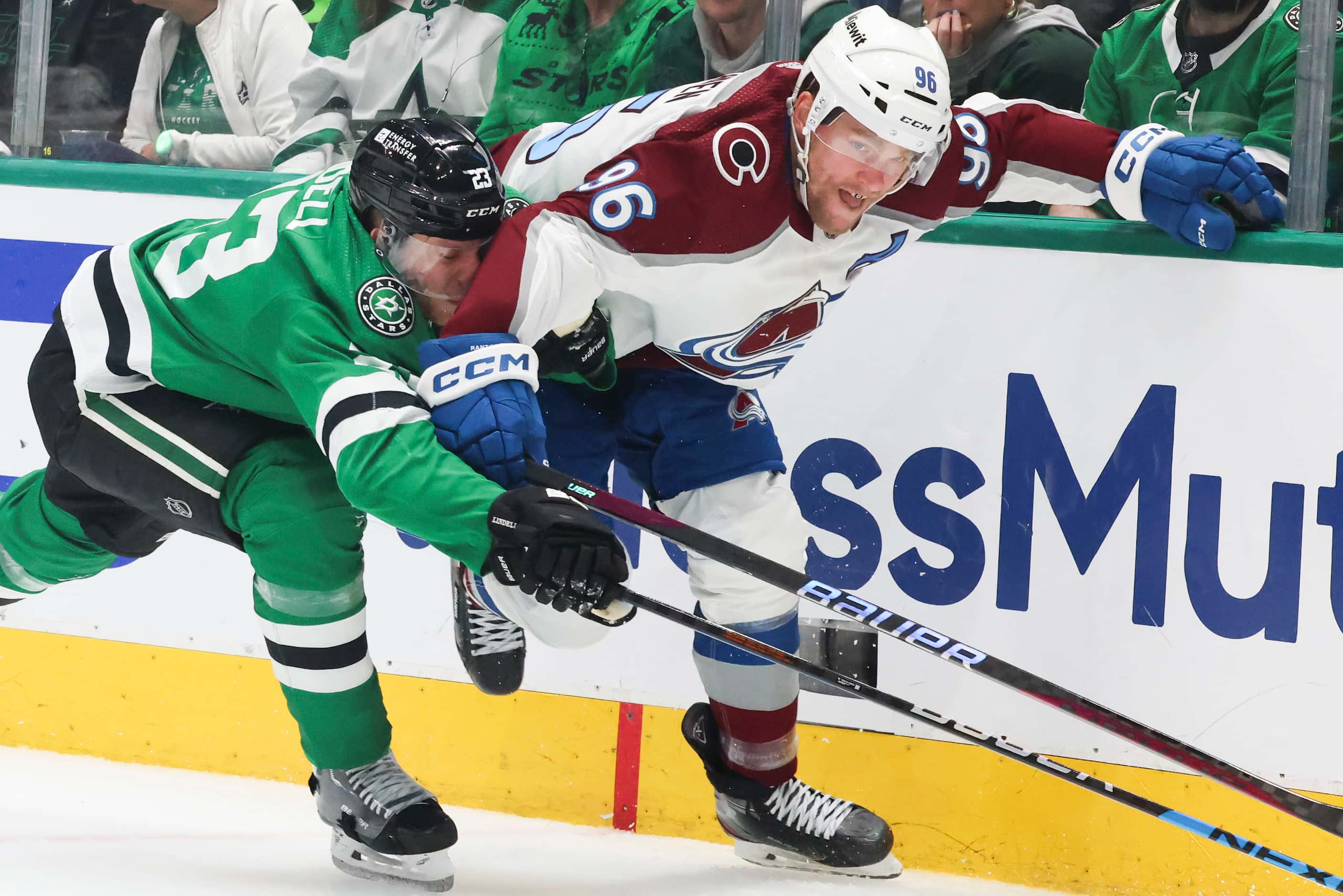 Dallas Stars defenseman Esa Lindell (left) competes for the puck against Colorado Avalanche...