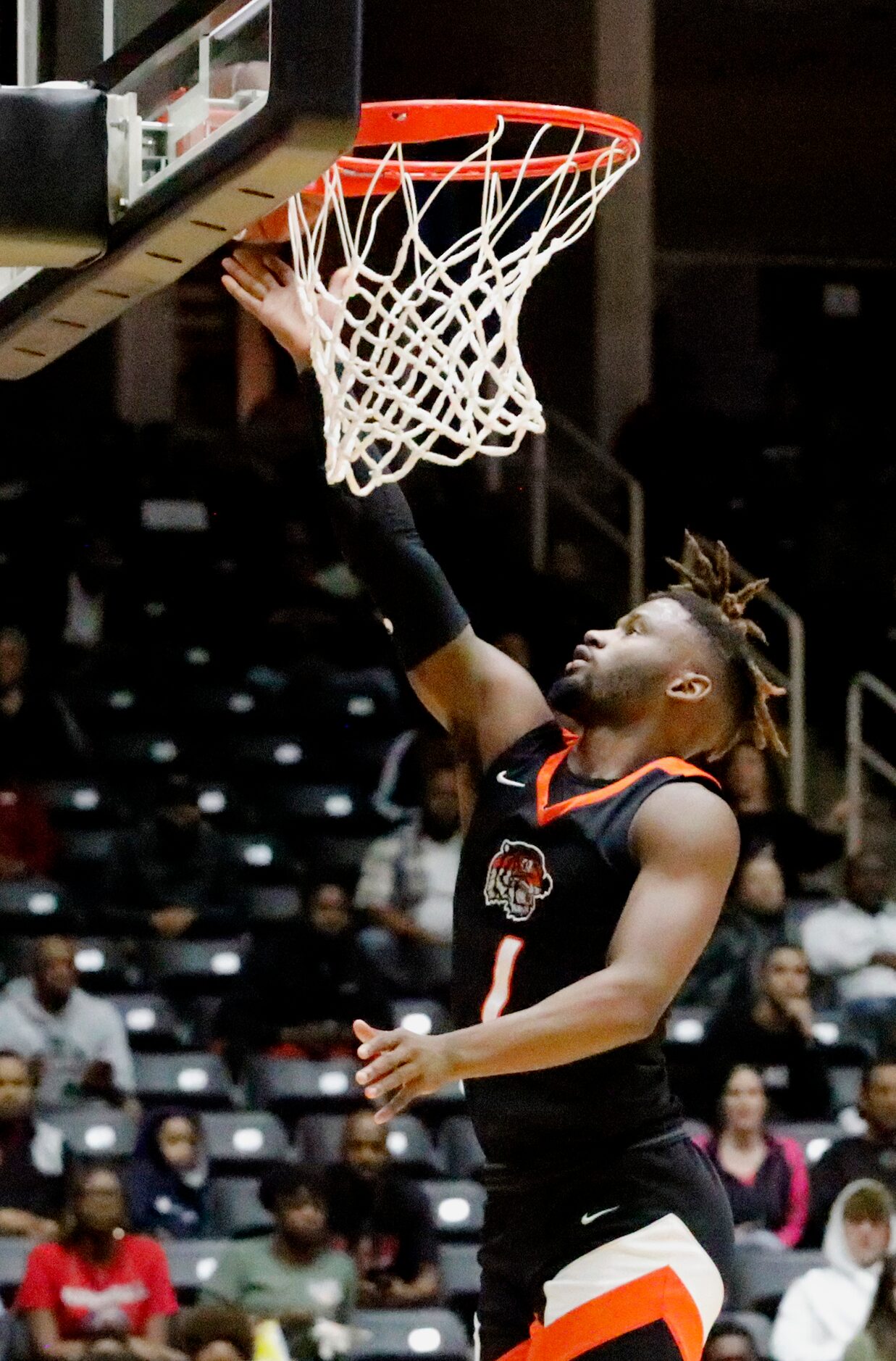 Lancaster High School guard Mike Miles (1) goes in for a layup during the first half as...