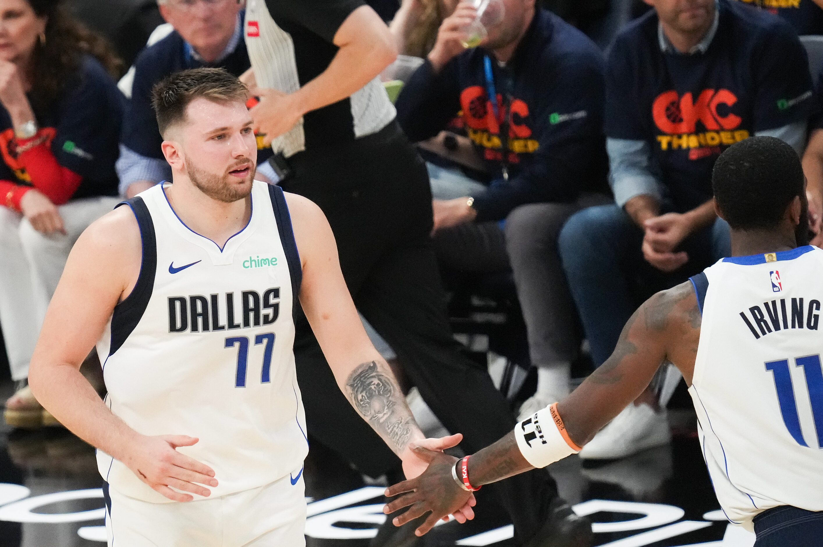 Dallas Mavericks guard Luka Doncic (77) celebrates a basket with guard Kyrie Irving (11)...