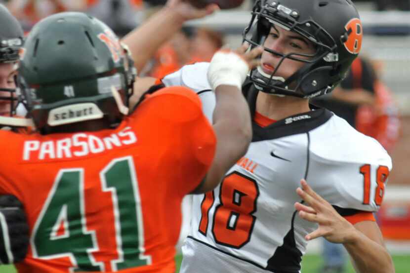 Rockwall sophomore quarterback Will Reed (18) passes as Naaman Forest senior Marcus Parsons...