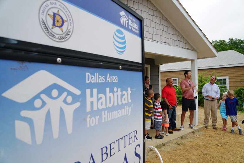 The Campos family (left) and David McAtee of AT&T and his children (right) looked on as...