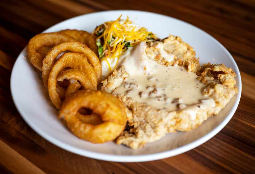 Mex-Tex Chicken Fried Steak topped with Chorizo Gravy and served with mashed potatoes and...