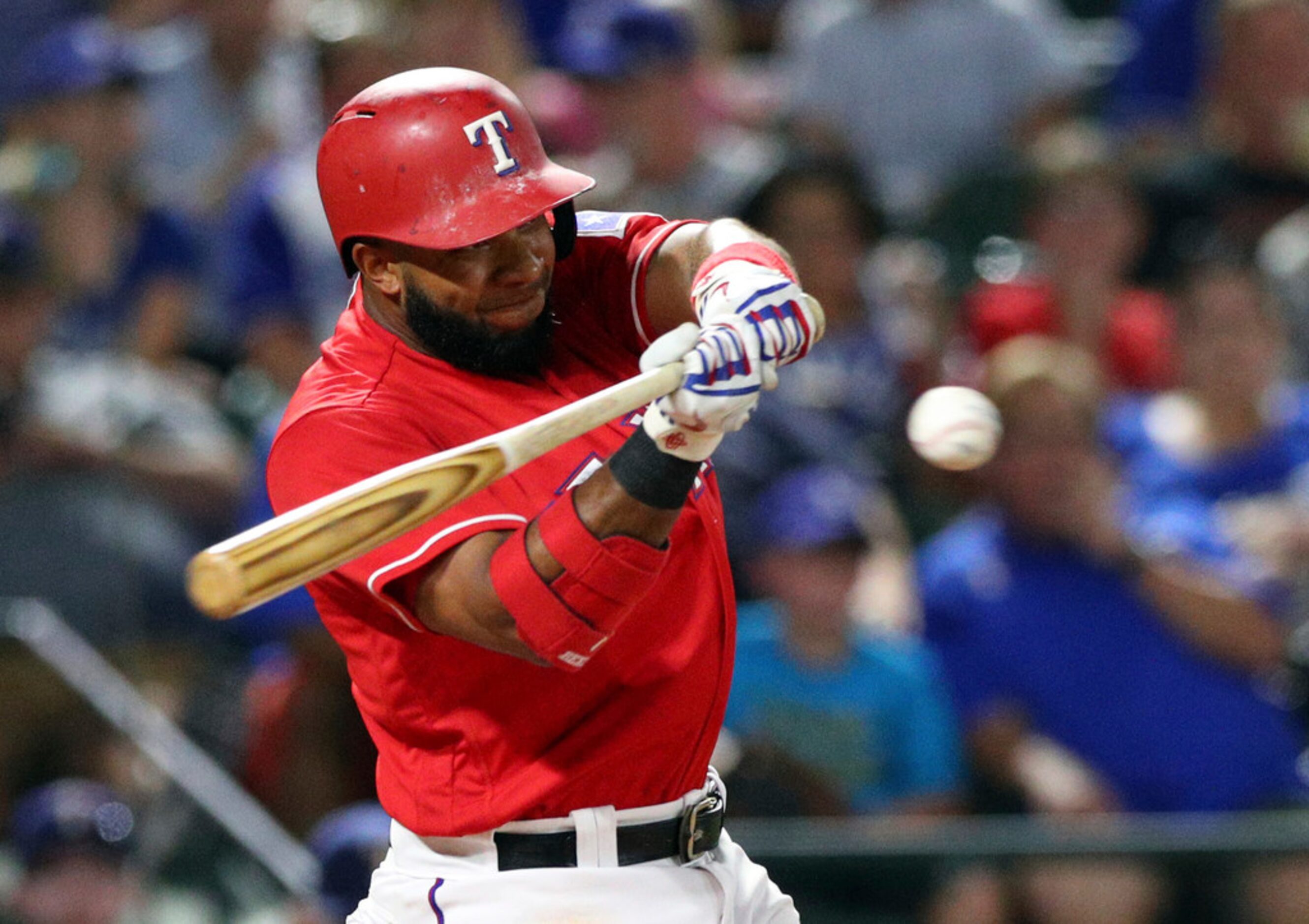 Texas Rangers shortstop Elvis Andrus (1) hits for an RBI single in the third inning of a...