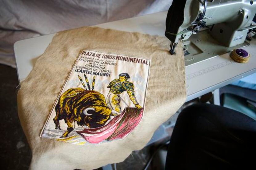 
An old feed sack is stitched to vintage linen to create an ottoman cover. The fabrics are...