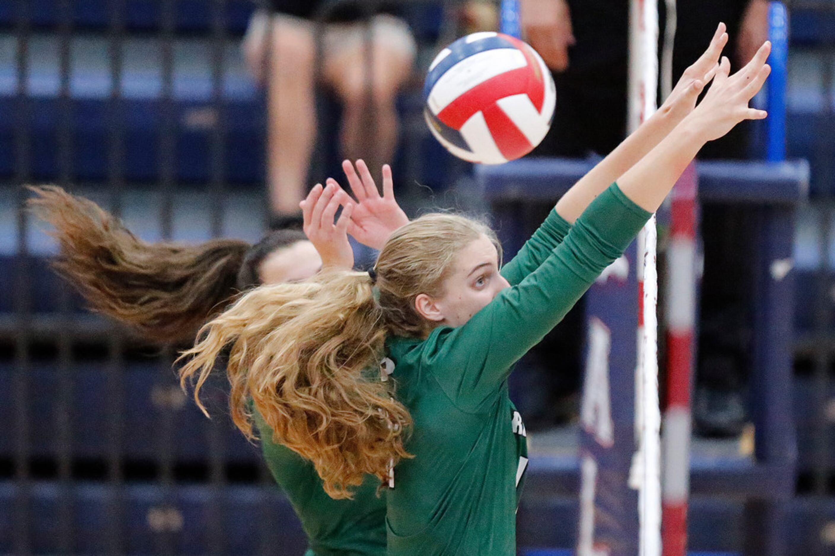 Prosper High School middle blocker Shaylee Shore (11) attempts a block during game one as...