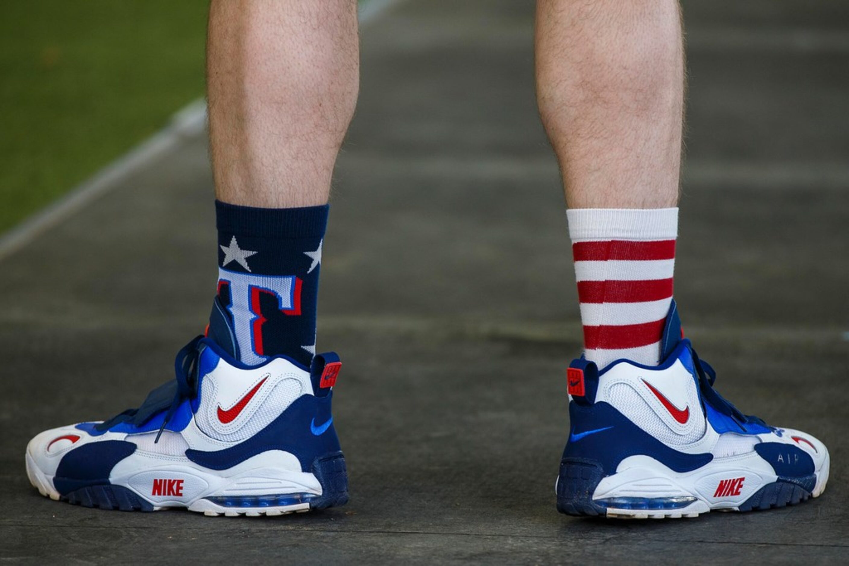 Texas Rangers infielder Patrick Wisdom wears colorful Rangers socks in the batting cages...