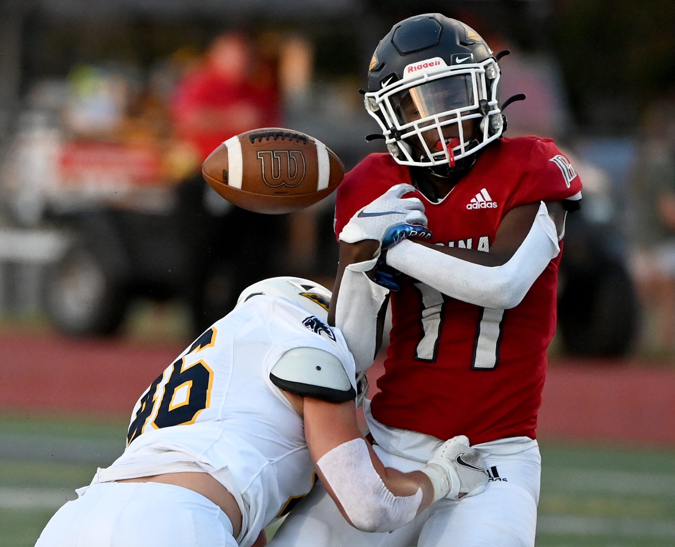 Prestonwood's Hudson Lunsford (46) makes a hit to cause a fumble on John Paul II's Caesar...