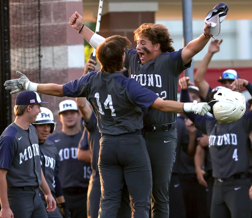 Flower Mound's Evan Rolison (14) celebrates with Creed Thomas (22) after hitting a home run...