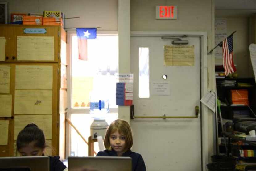 
Third-grade students Victoria Velasquez (left) and Macey Scurria attend class in one of the...