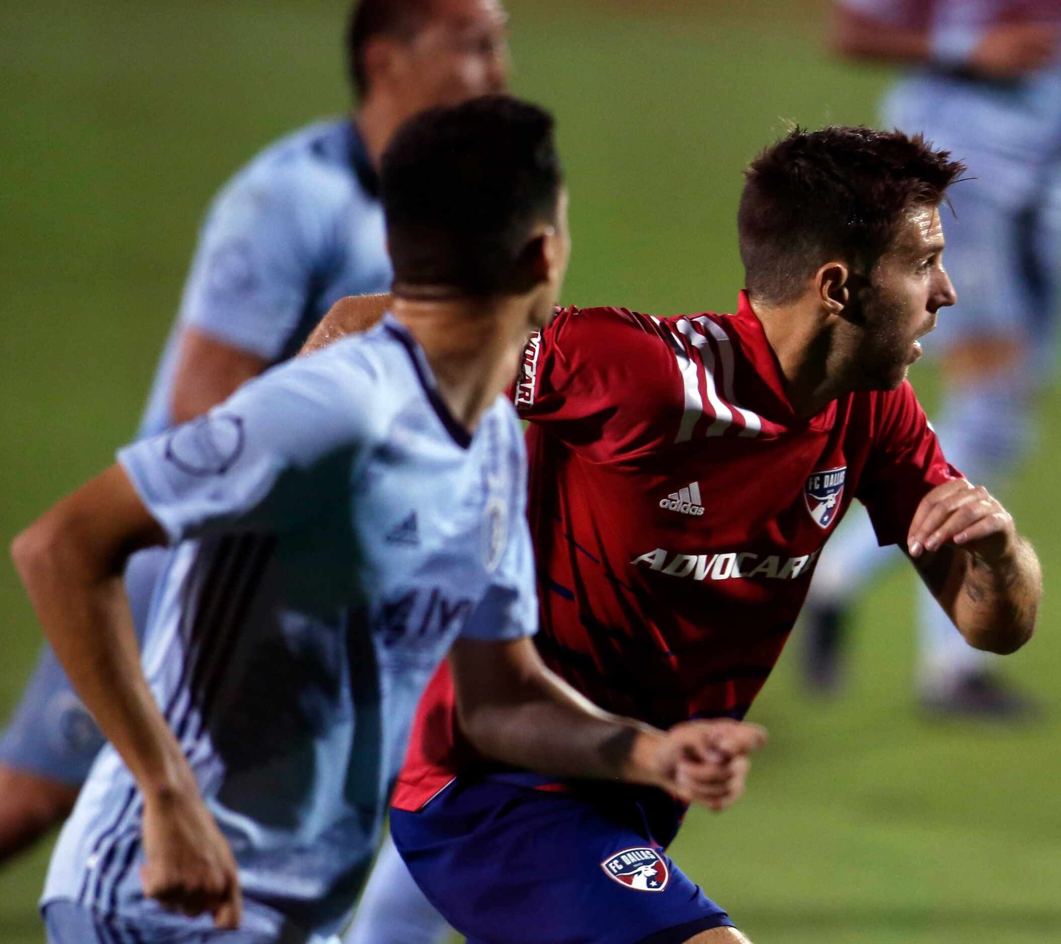 FC Dallas' Ryan Hollingshead (12), right, sprints in to help defend against a Sporting KC...