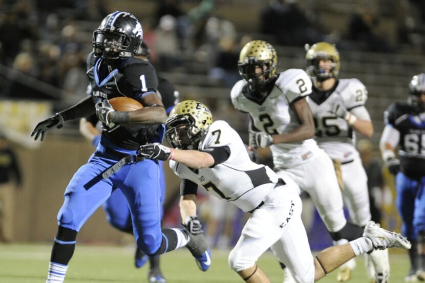 Plano West's Sotonye Jamabo runs past Plano East's Zack Mueller (7) during a Class 5A high...