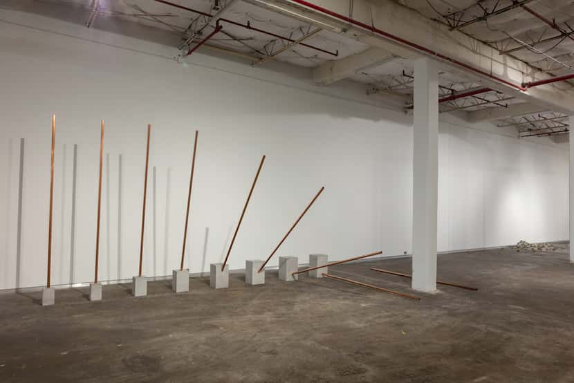 Alicja Kwade's Fall shows a vertical pipe  falling  from vertical to horizontal, appearing...