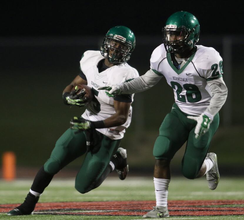 Kennedale running back Daily Wells (5) looks for running room as he follows the block of...