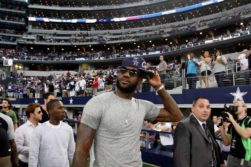 Miami Heat's LeBron James takes a look at the stadium as he makes his way to the Dallas...