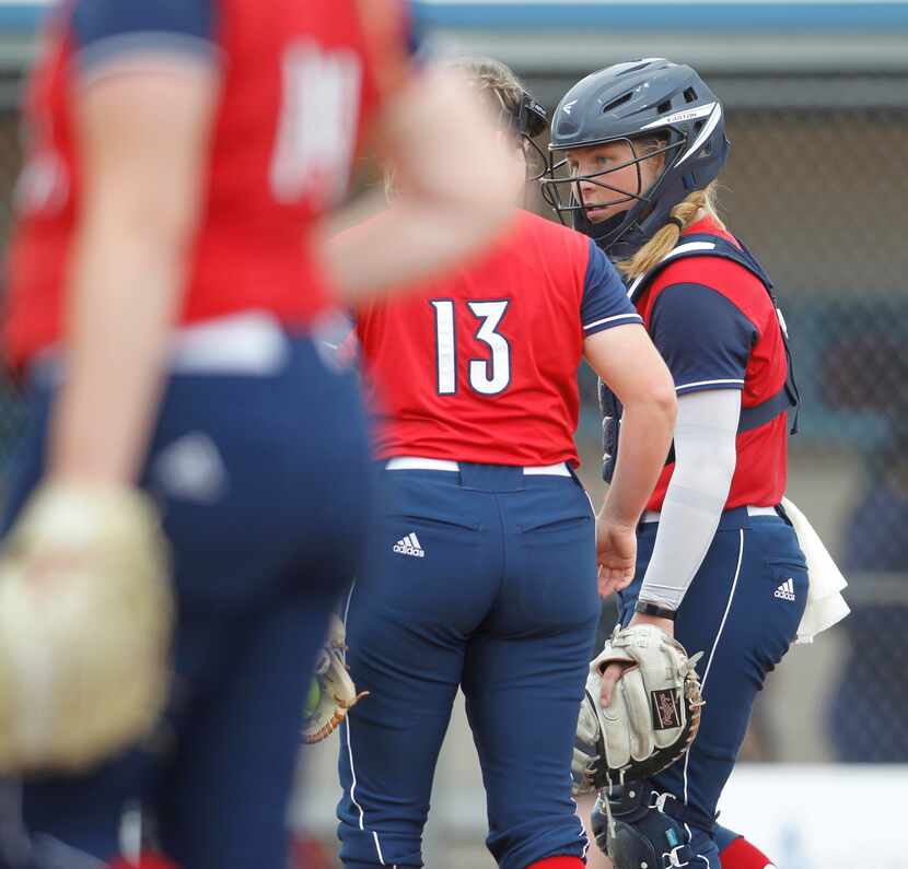 Plano John Paul ll catcher Aubrey Hutzler (6) speaks with pitcher Emily Jonte (13) during a...