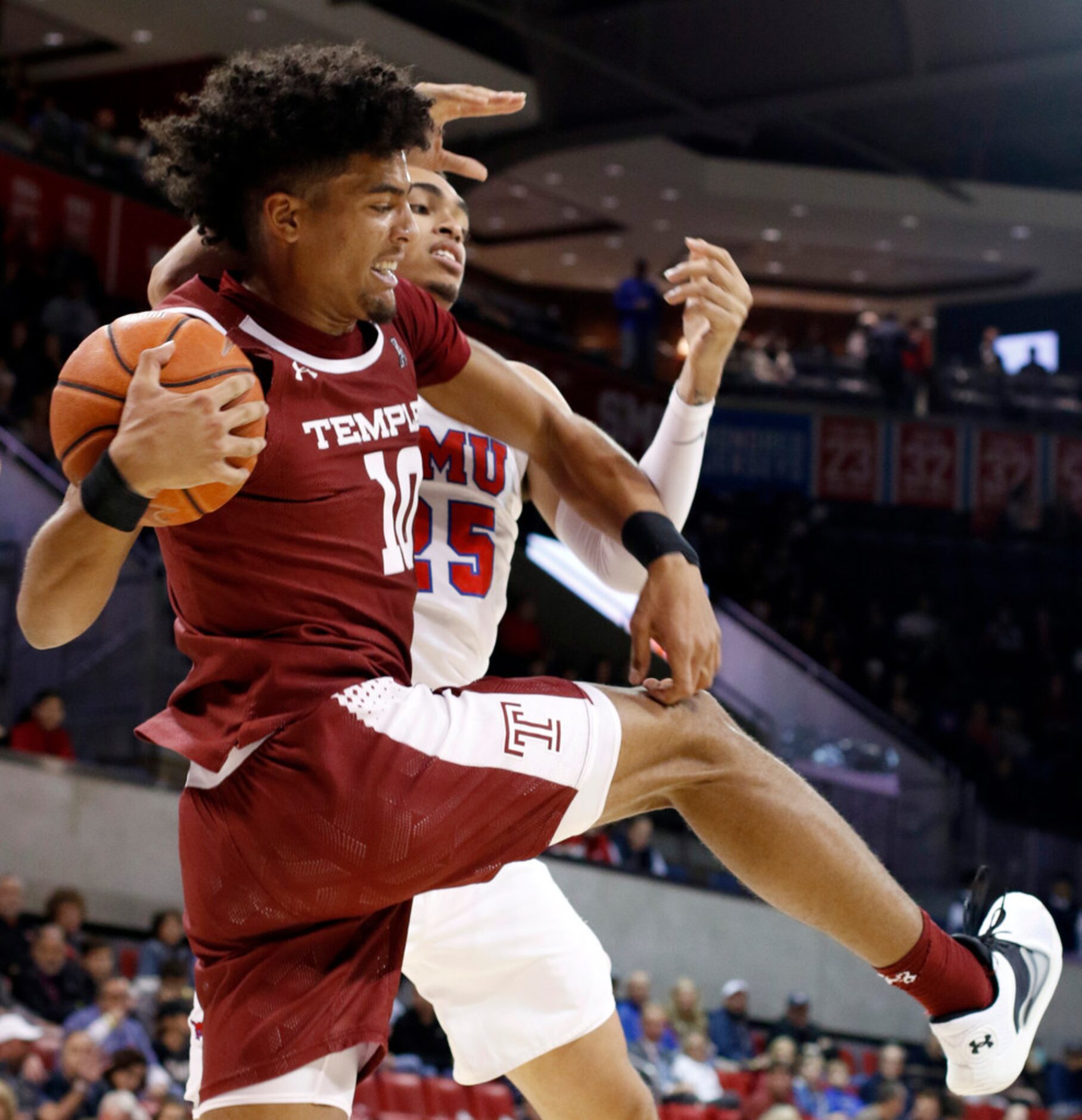 SMU forward Ethan Chargois (25) battles with Temple forward Jake Forrester (10) for a...