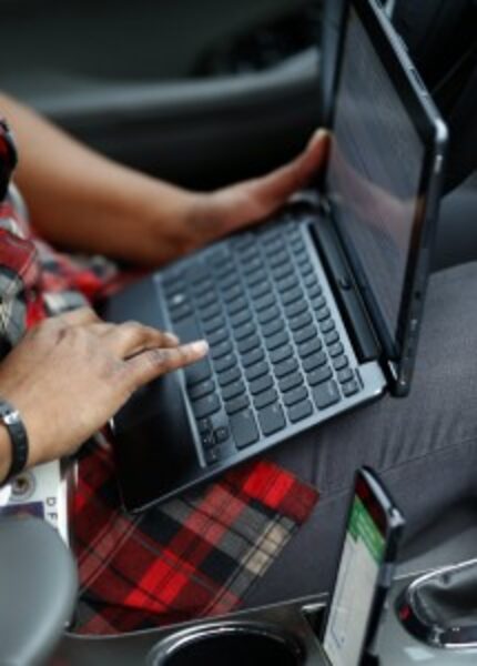  Pruitt checks an email inside her car after visiting the Dallas family. (Jae S. Lee/Staff...