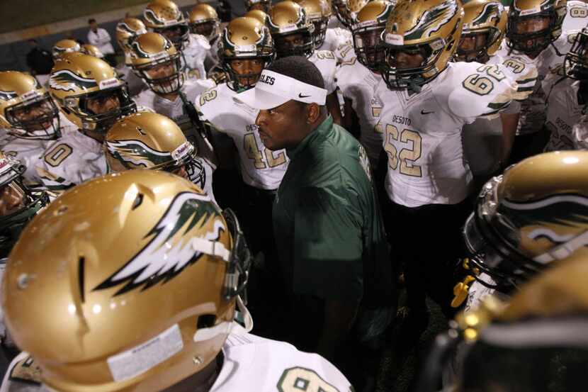 FILE - DeSoto head coach Claude Mathis talks to his team before the start of the football...