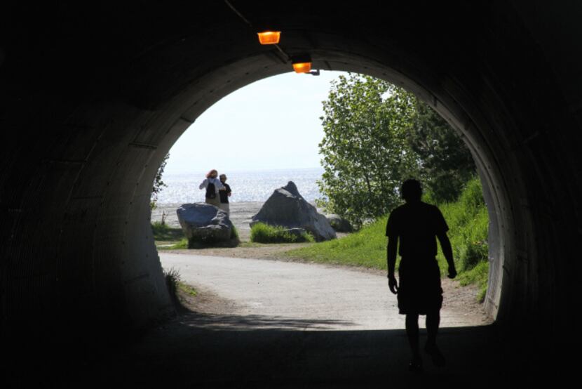 This photo taken June 11, 2013, shows a man running in a tunnel along the Tony Knowles...