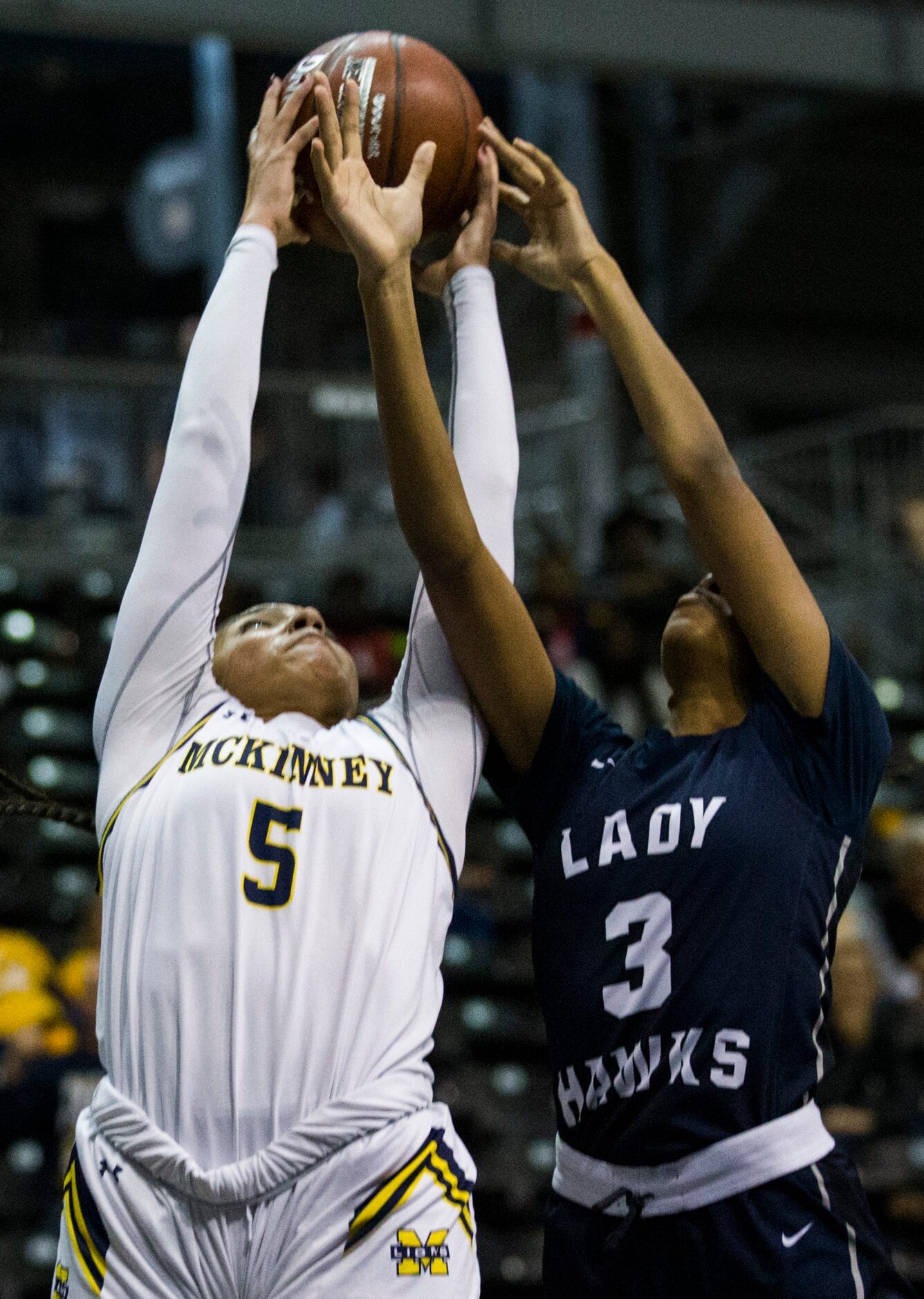 McKinney guard Trinity White (5) and Pflugerville Hendrickson guard Maci Quiller (3) reach...