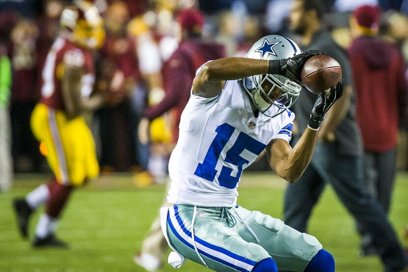 Dallas Cowboys wide receiver Devin Street (15) catches a pass as he warms up before an NFL...