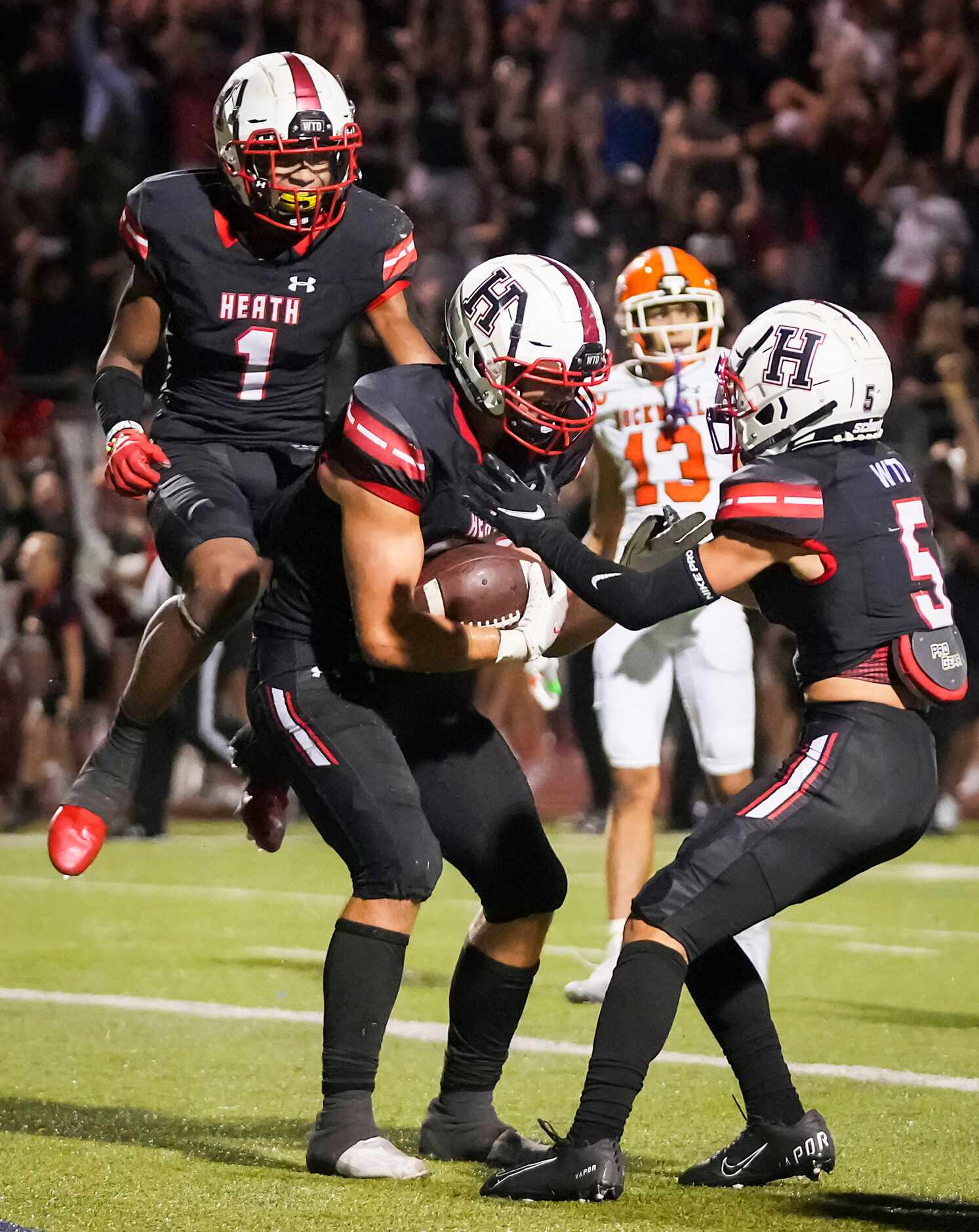 Rockwall-Heath tight end  Lance Mason (38) celebrates with wide receivers Jay Fair (1) and...