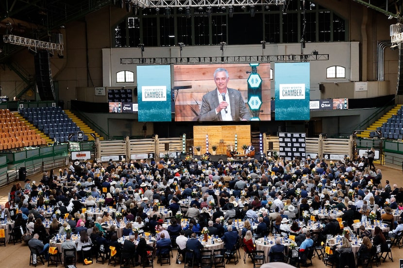 American Airlines President Robert Isom, on the screen,  speaks during the Fort Worth...