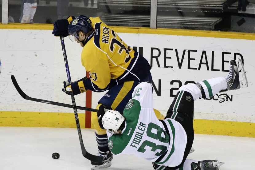 Dallas Stars center Vernon Fiddler (38) falls as he chases the puck with Nashville Predators...