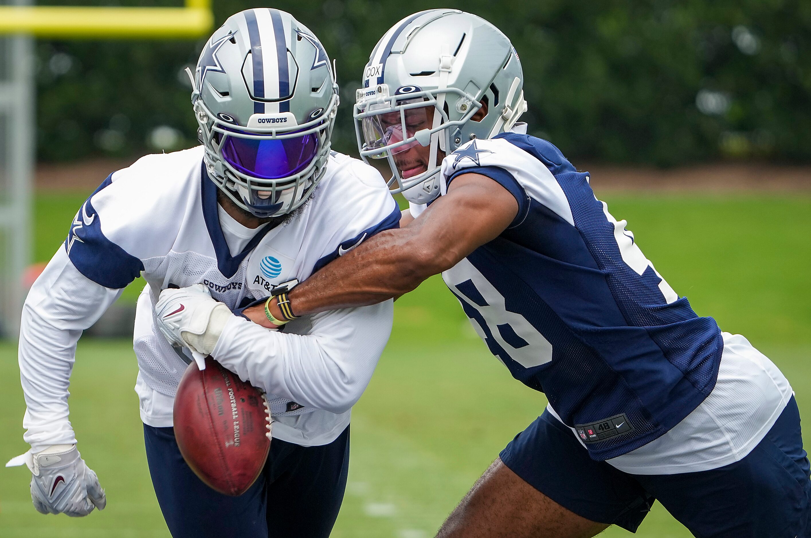 Dallas Cowboys linebacker Jabril Cox (48) knocks the ball away from running back Ezekiel...