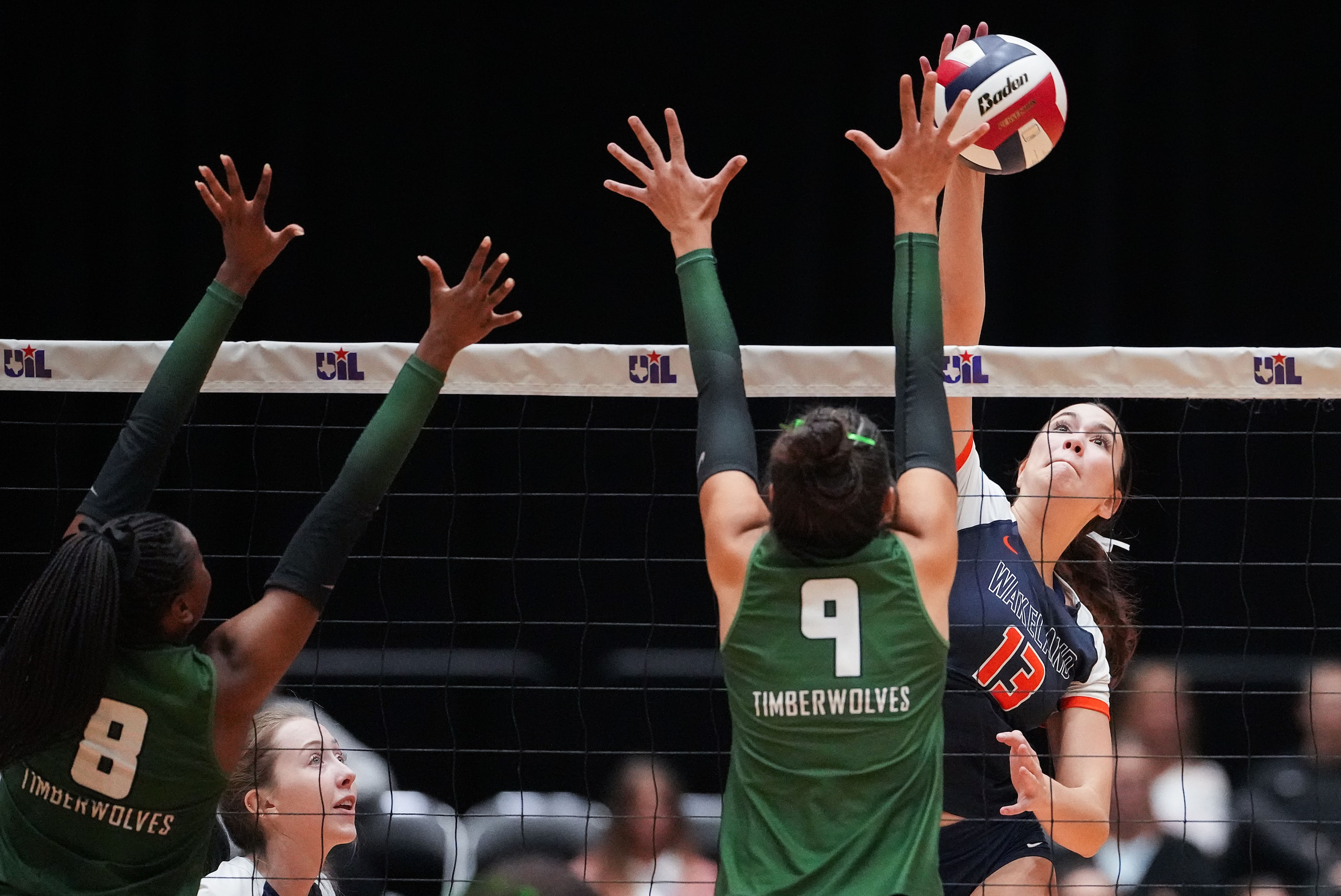 Frisco Wakeland's Emerson Jones (13) hits over Cedar Park's Sofia Peters (9) and Mya Cheatum...