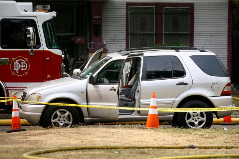 A Mercedes SUV , surrounded in police tape, was the site of an officer’s shooting of a...