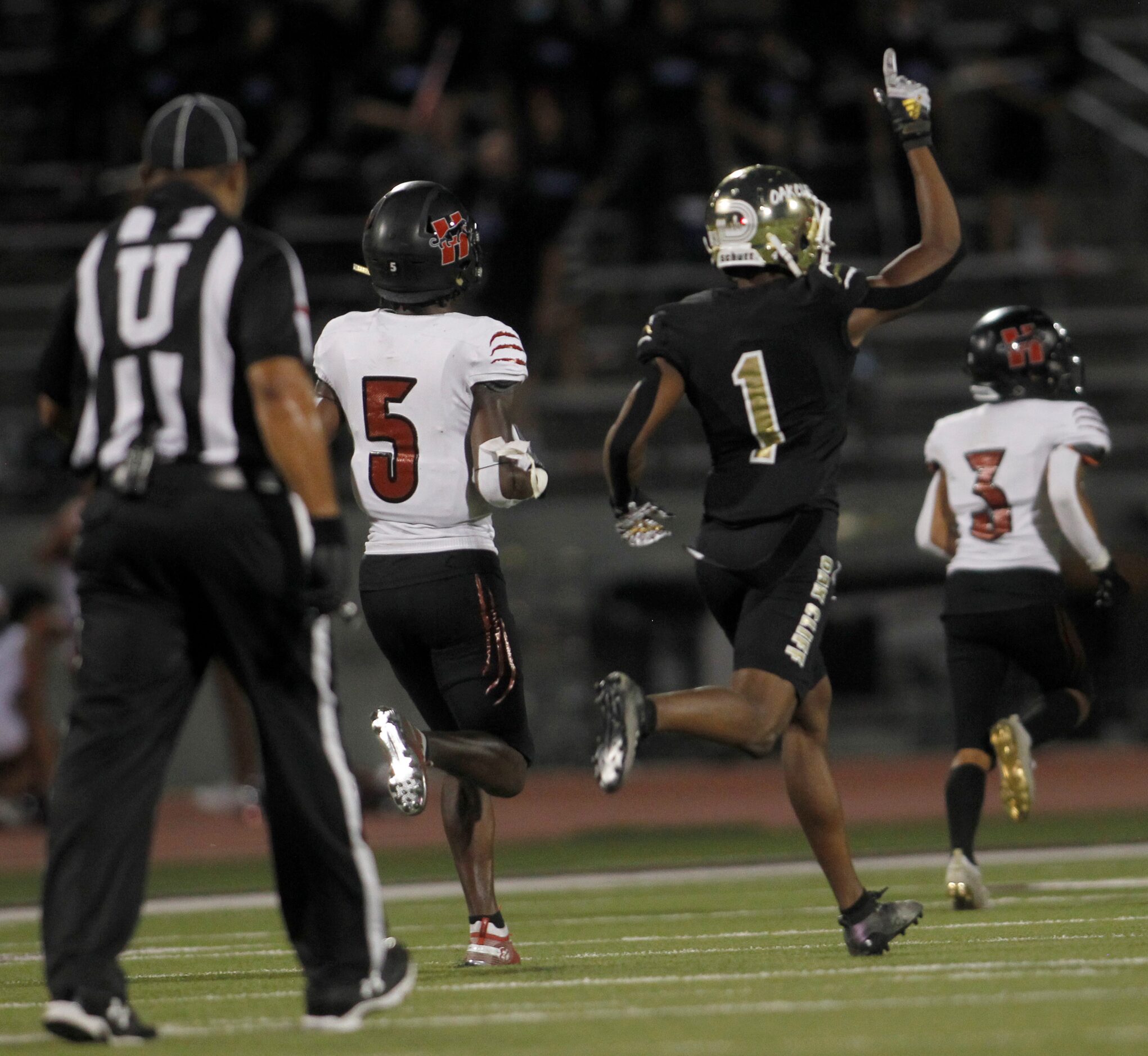 South Oak Cliff defensive back Manny Muhammad (1) gestures upward in celebration after a...