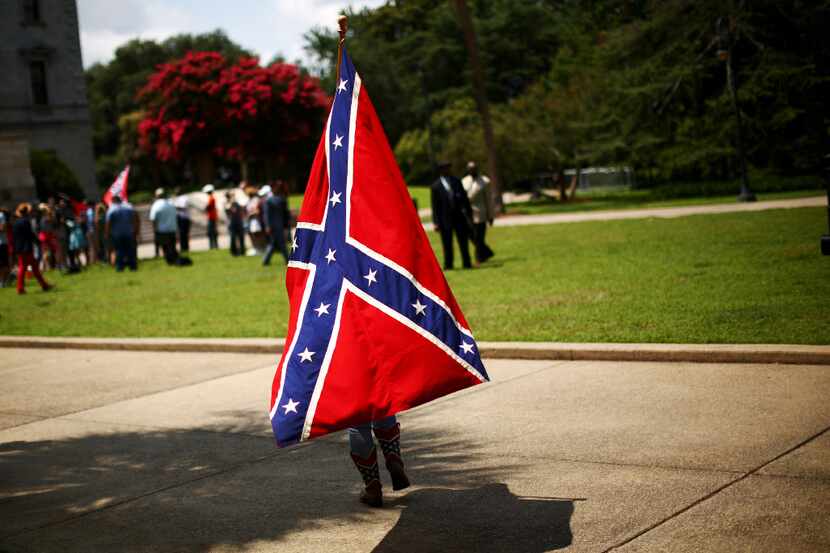FILE -- A Confederate Battle flag supporter outside South Carolina's State House as the...