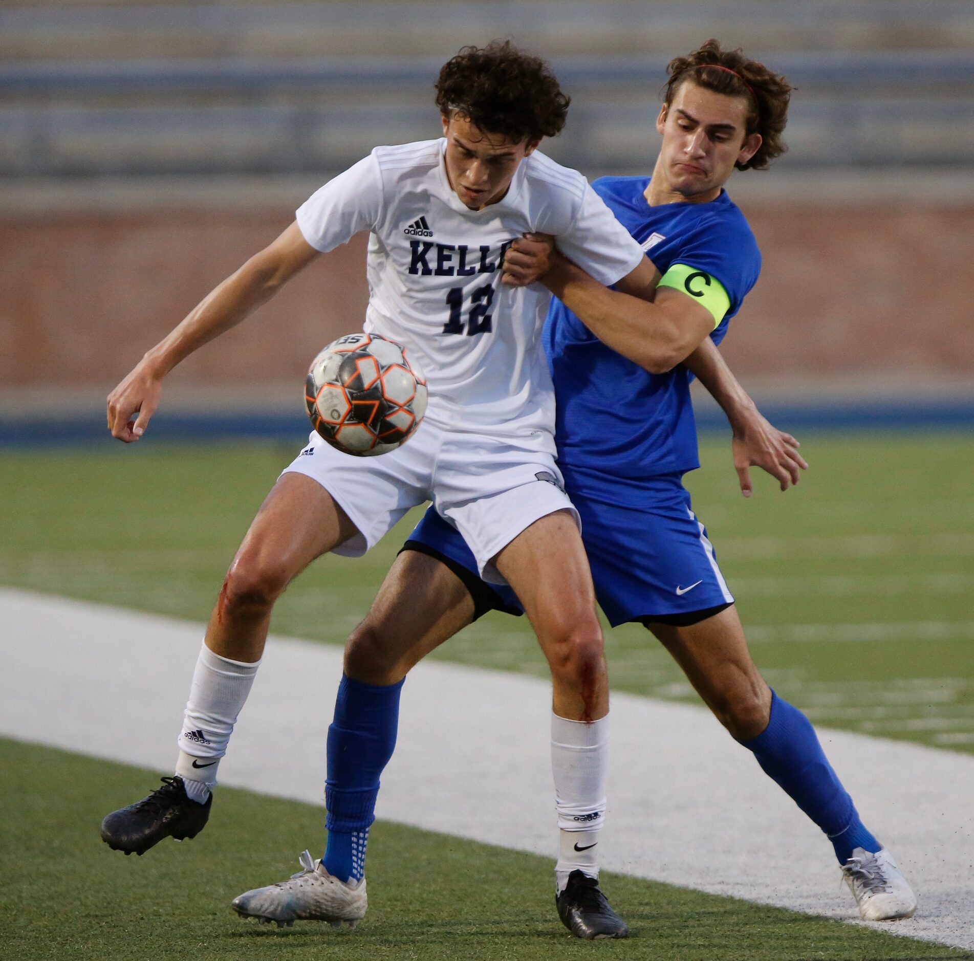 Keller midfielder Tom Brown (18) shields Allen defender Chase Duhon (2) from the soccer ball...