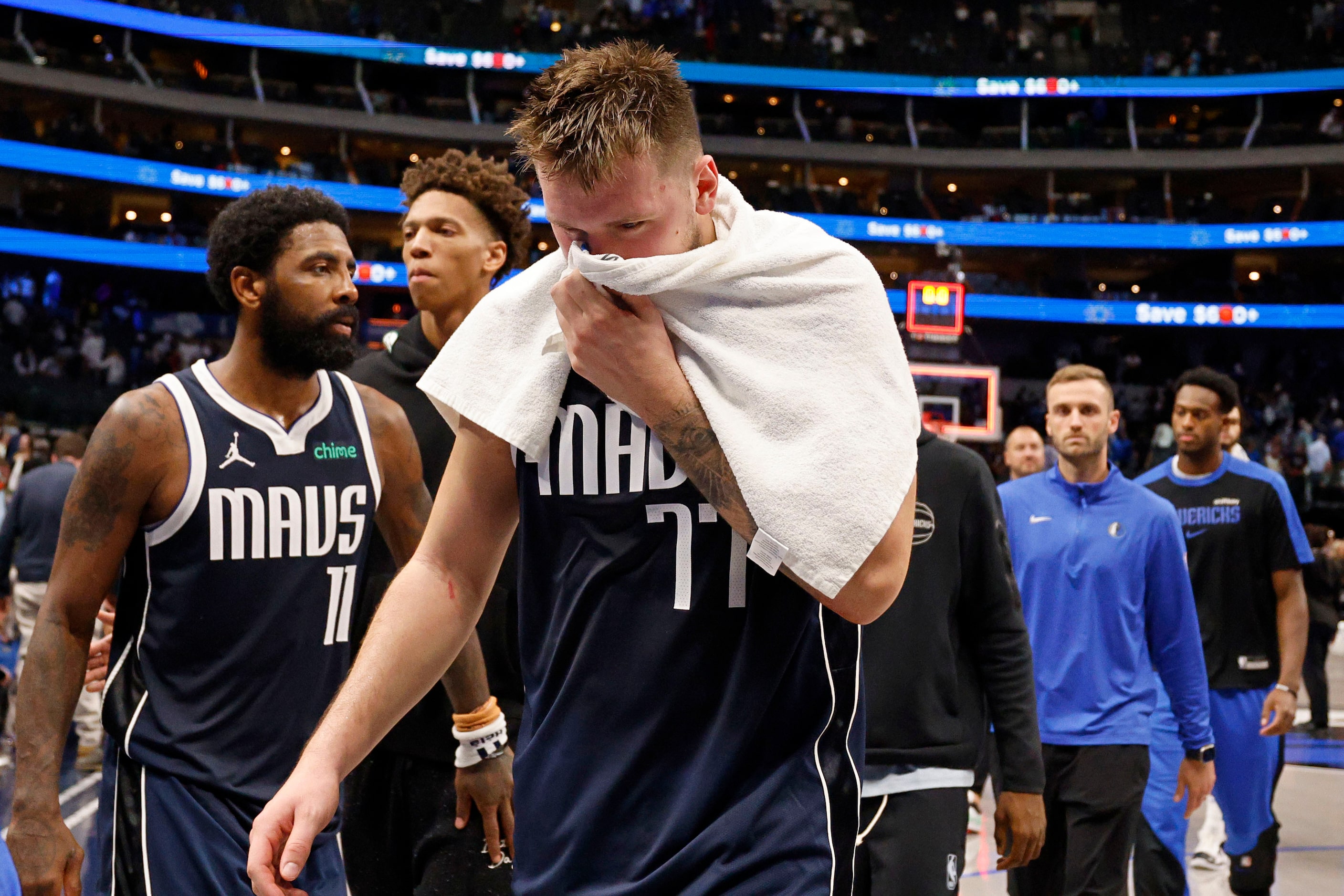 Dallas Mavericks guard Luka Doncic (77) leaves with his teammate Kyrie Irving (11) after...