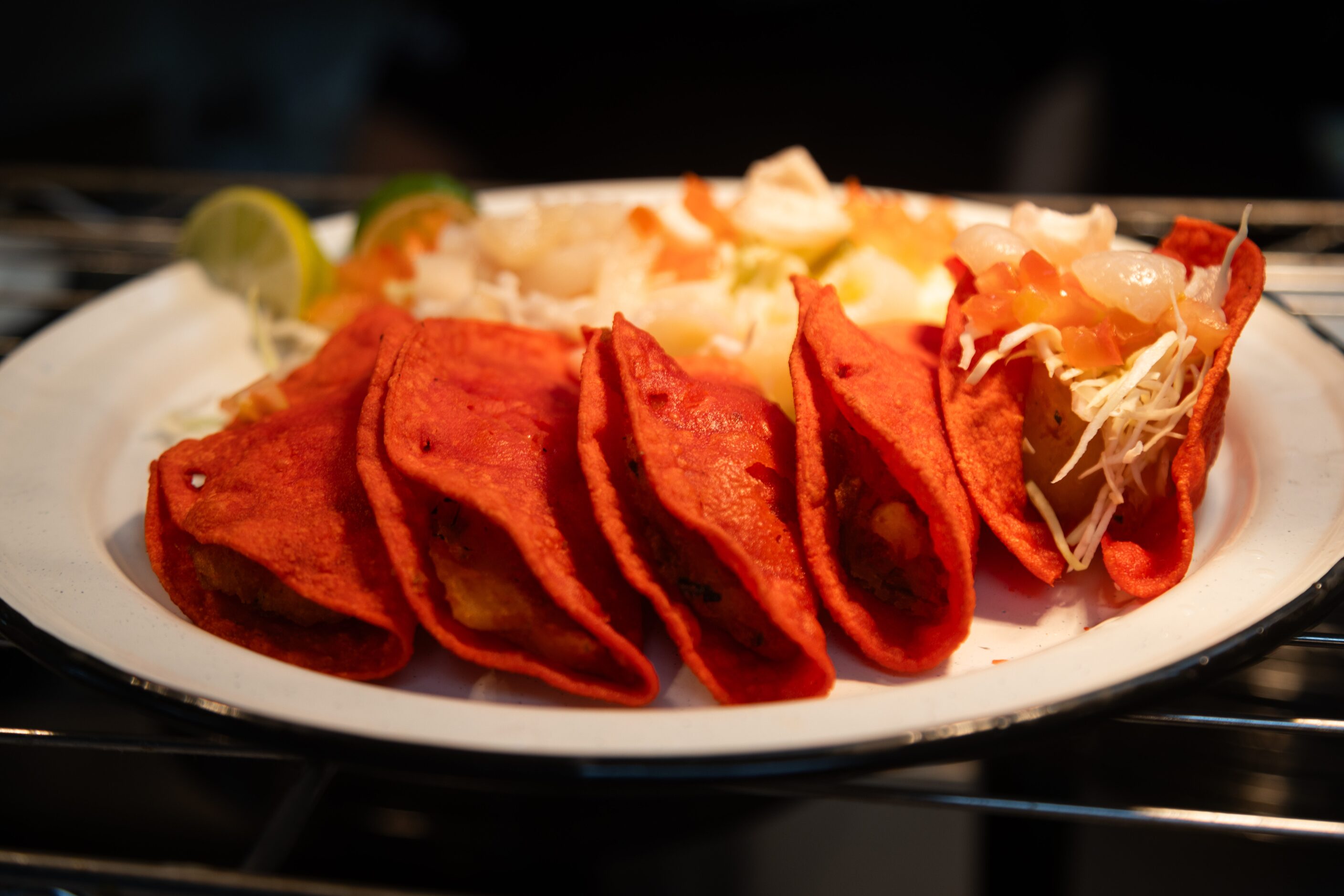 Red taquitos, potato-filled tacos made in a red corn tortilla and eaten with cabbage and...