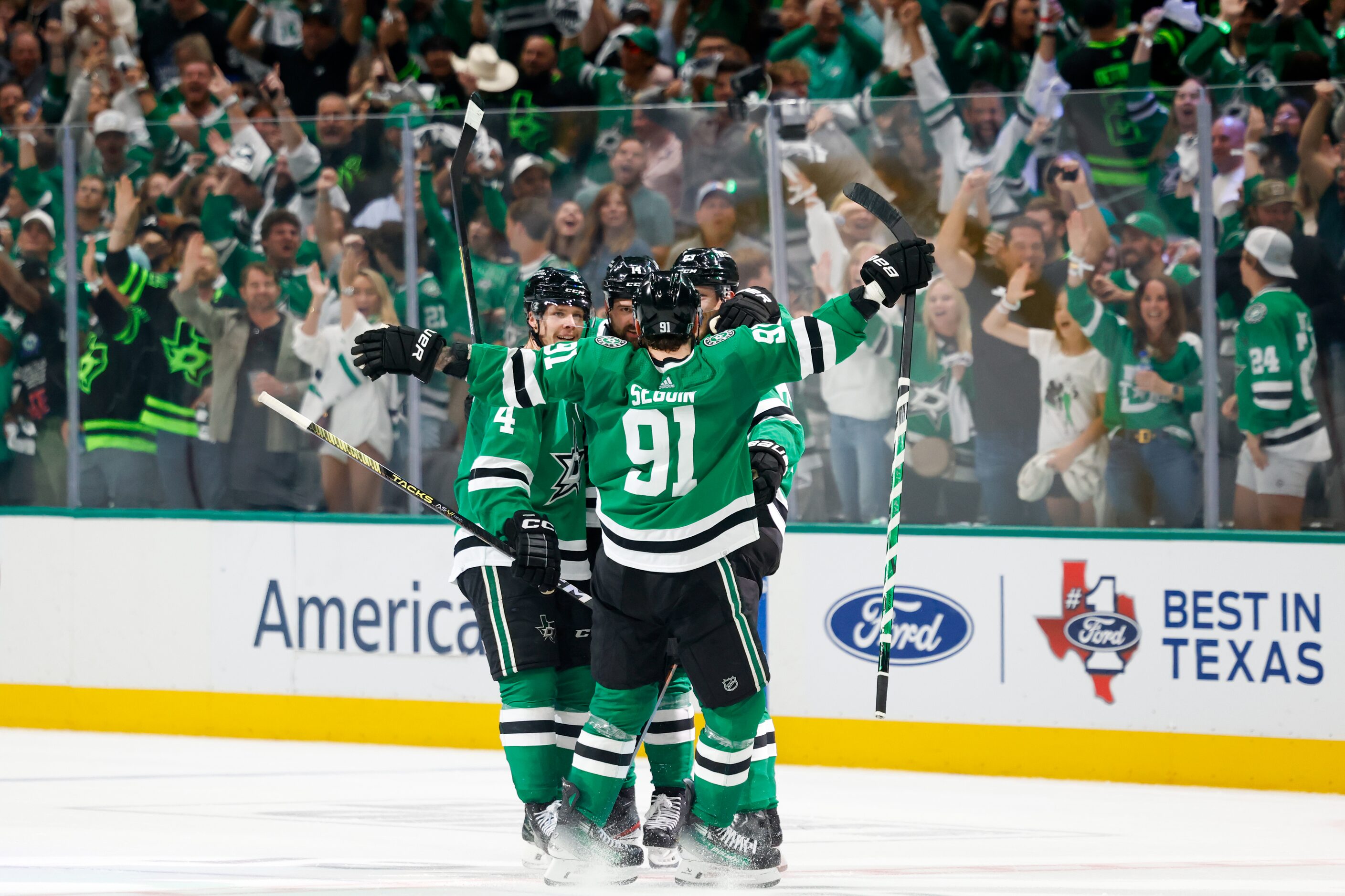 Dallas Stars center Tyler Seguin (91) celebrates an empty-net goal by defenseman Esa Lindell...