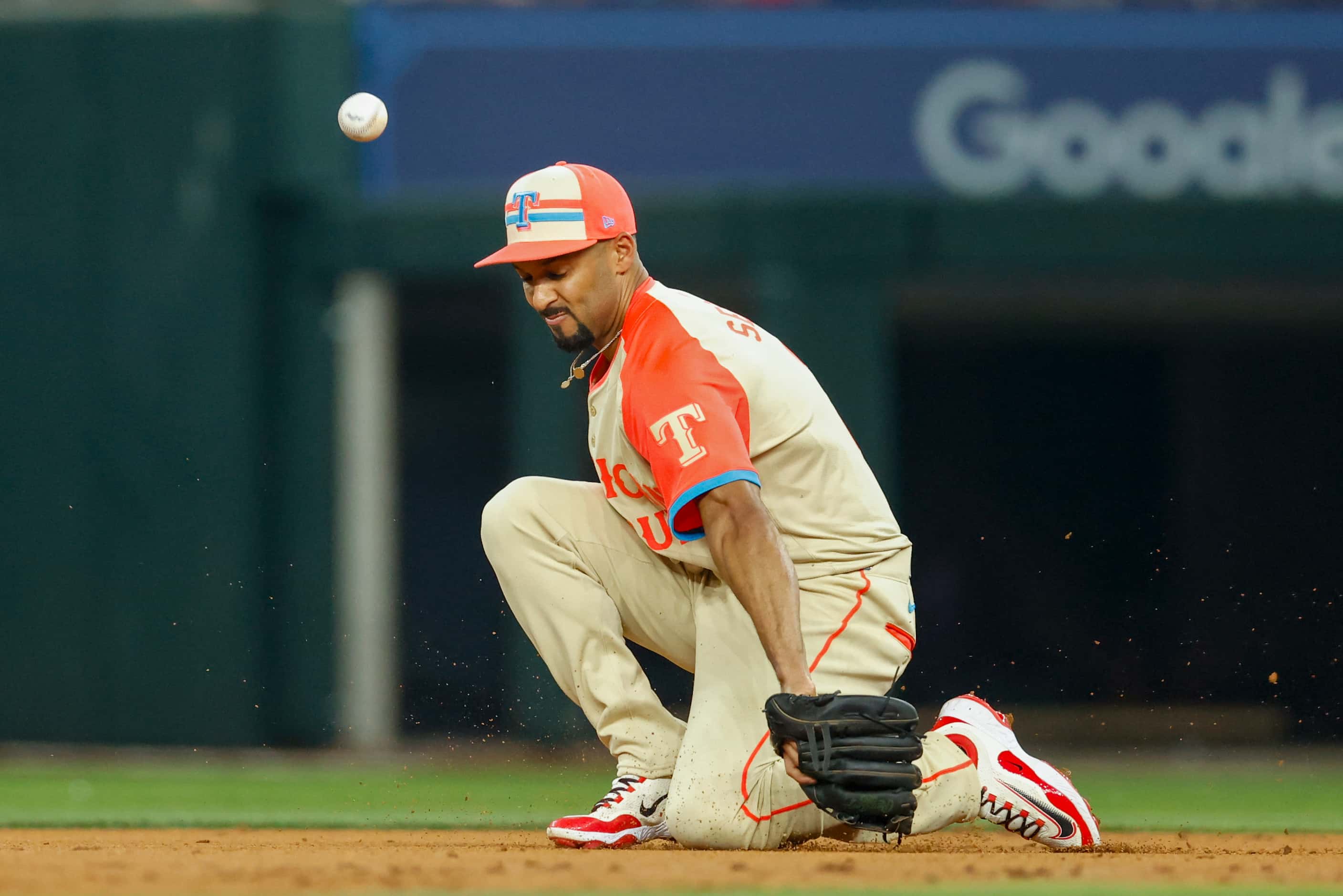 American League's Marcus Semien, of the Texas Rangers, misplays the ball during the third...