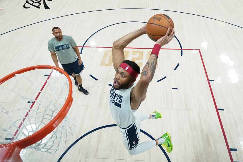Denver Nuggets forward Bruce Brown, right, dunks during warmups before Game 5 of...