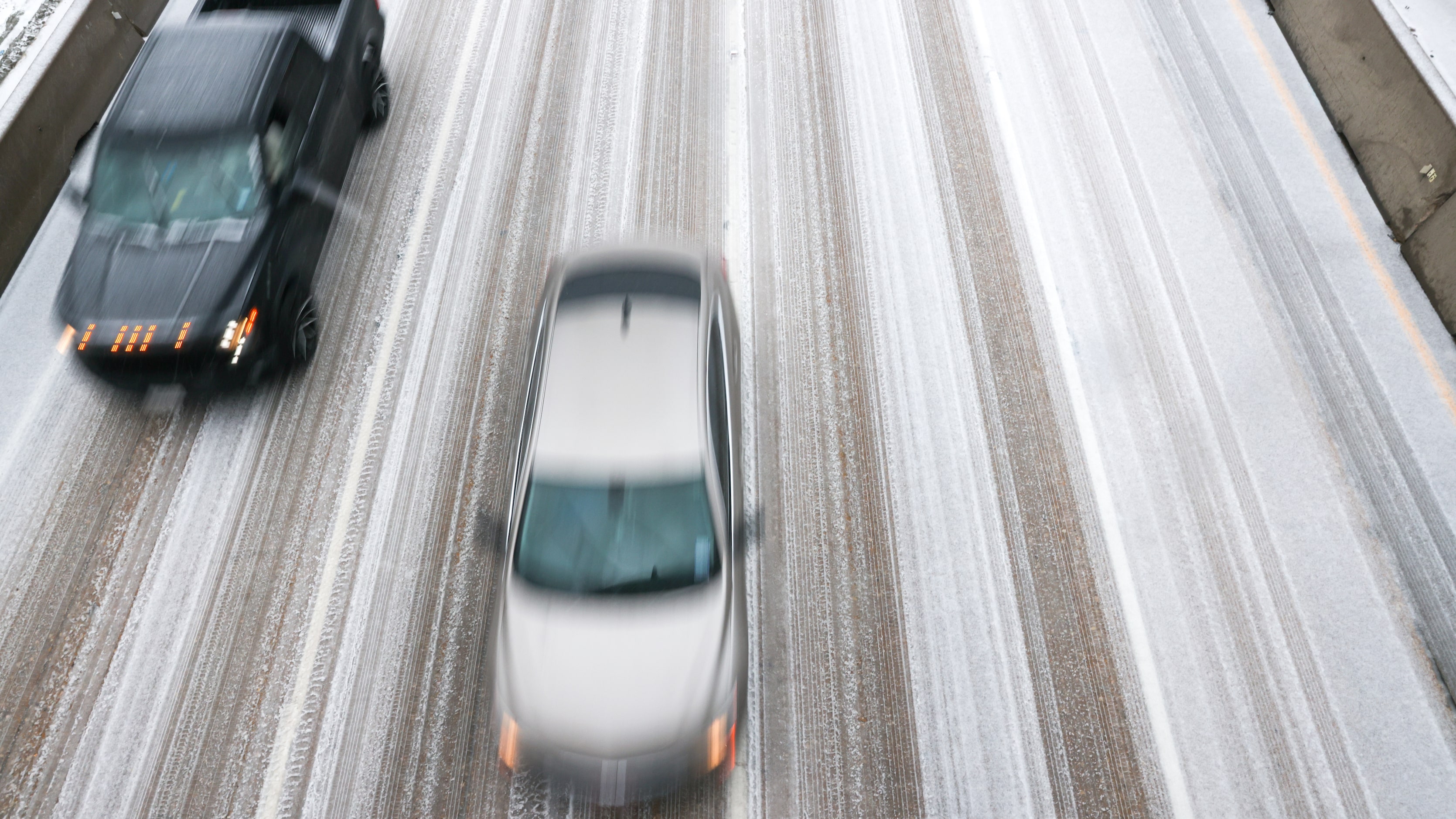 Cars move along icy roads on U.S. 75 near Skillman Street in Dallas on Tuesday, Jan. 31,...